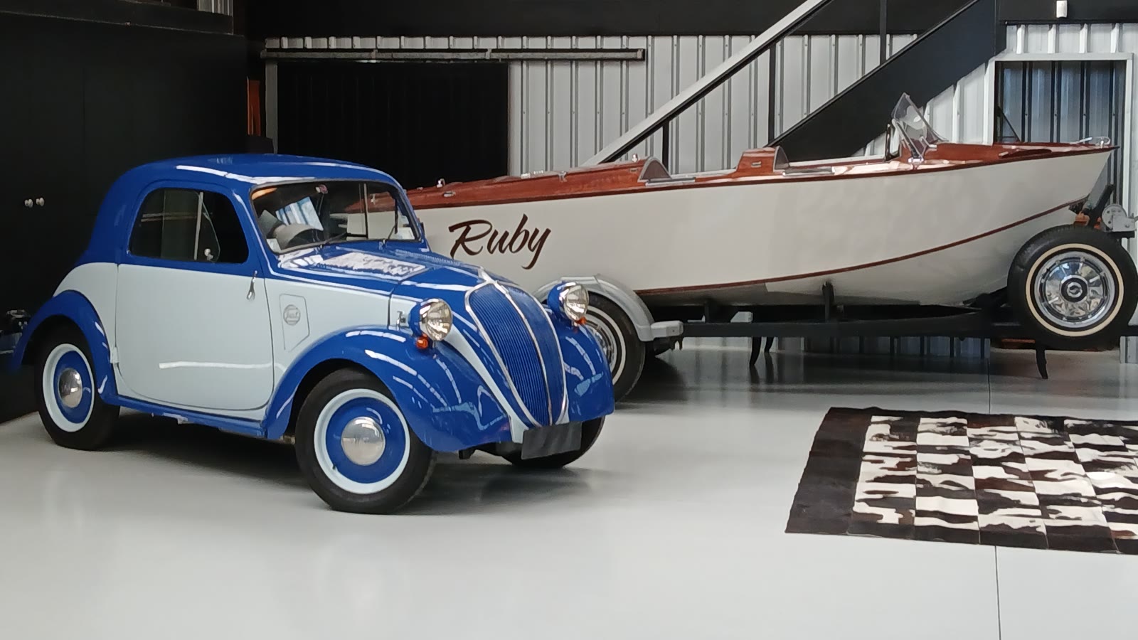 The classic boat Ruby on her trailer with the Fiat 500 Topolino